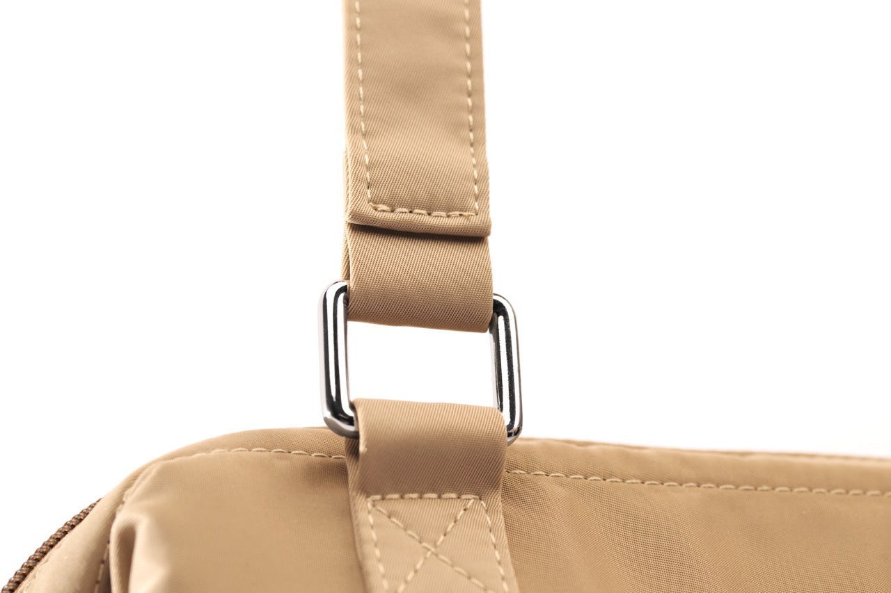 STÆRKE mini gym bag strap attachment detail with reinforced stitching and silver hardware