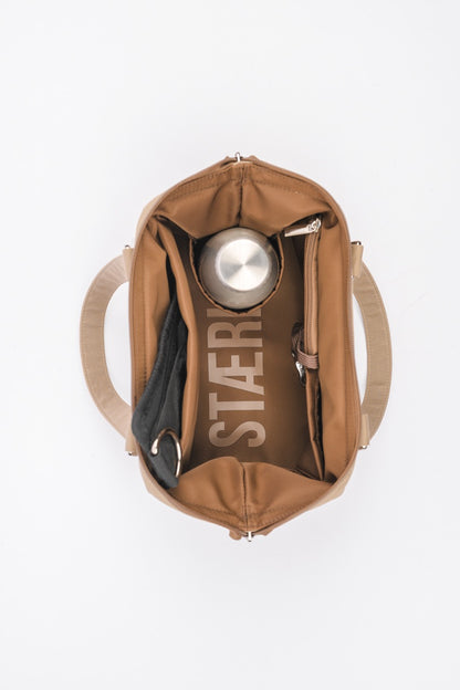 Inside view of STÆRKE mini gym bag with water bottle and compartments, recycled nylon